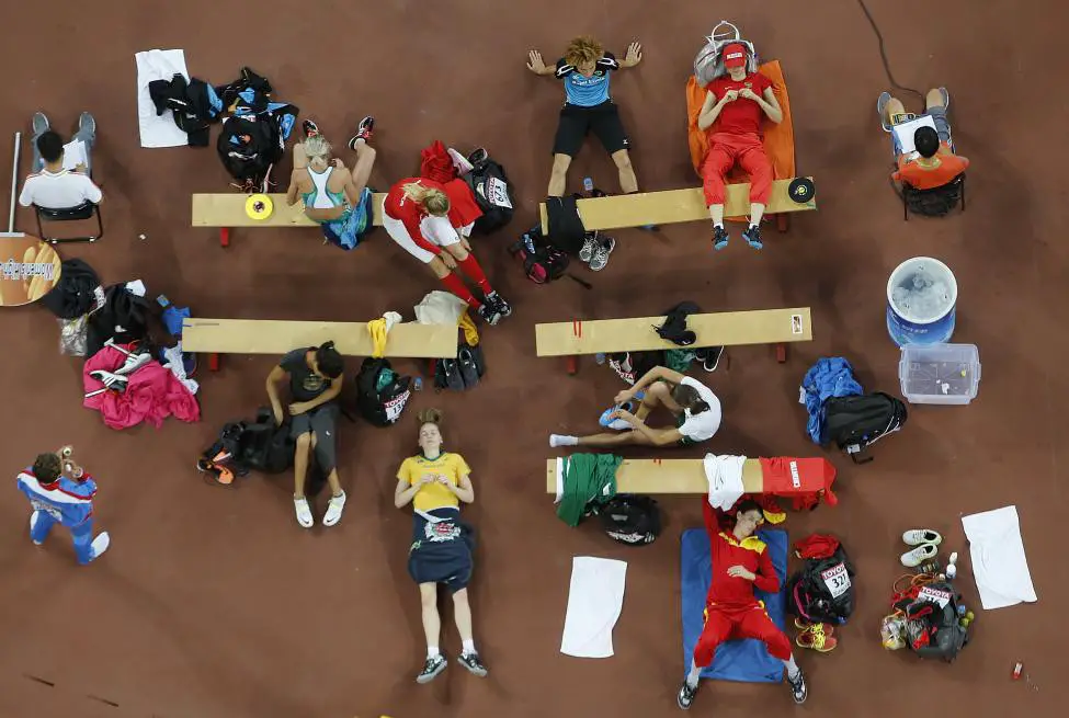Athletes wait for their turns at the women's high jump final during the 15th IAAF World Championships at the National Stadium in Beijing