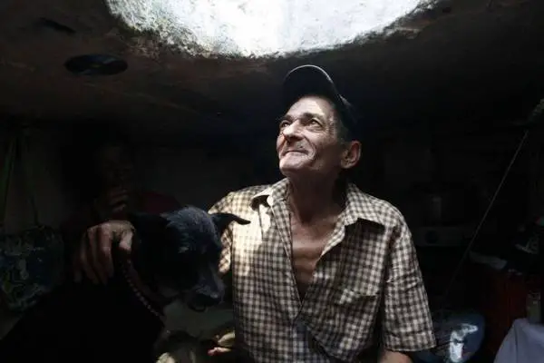 Restrepo looks up from his sewer home in Medellin