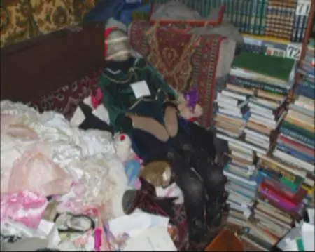 A still image taken from undated police footage shot inside the flat of Anatoly Moskvin shows books, clothes and dressed figures, reportedly mummified bodies desecrated from cemeteries