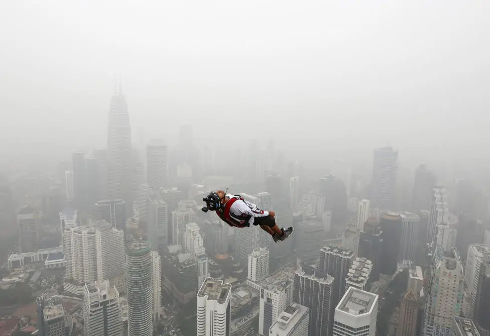 BASE jumper leaps from the 300-metre high Kuala Lumpur Tower during the International Tower Jump on a hazy day in Kuala Lumpur