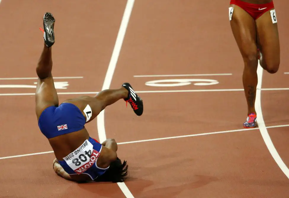 Tiffany Porter of Britain falls after competing in the women's 100 metres hurdles final during the 15th IAAF World Championships at the National Stadium in Beijing