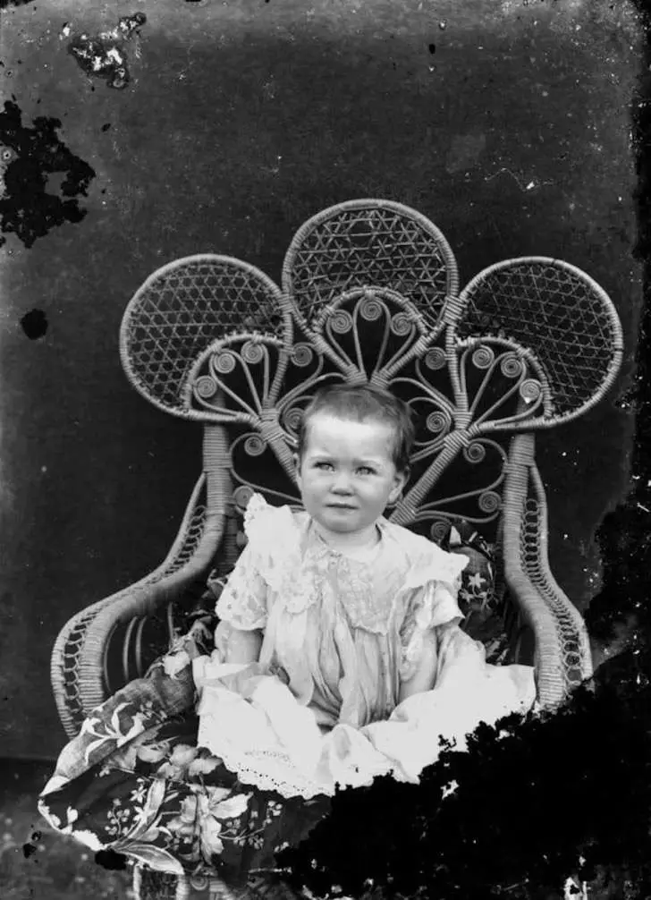 statelibqld_2_196311_portrait_of_an_unidentified_baby_sitting_on_an_elaborate_cane_chair_1900-1910-850x1175-2