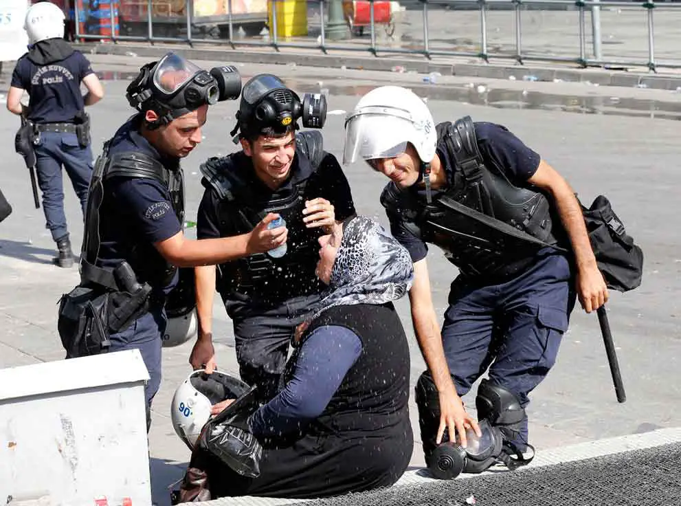 Policías-ayudan-a-mujer-afectada-por-el-gas-lacrimógeno.-Ankara-Turquía-2013.